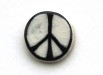 The first CND badge, featuring the CND symbol in black on white clay, as made by Eric Austen