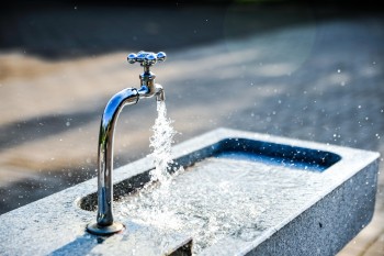 Wasserbecken mit laufendem Wasserhahn